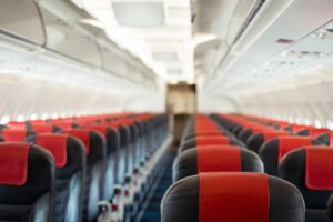 The inside of an airplane showing empty seats 