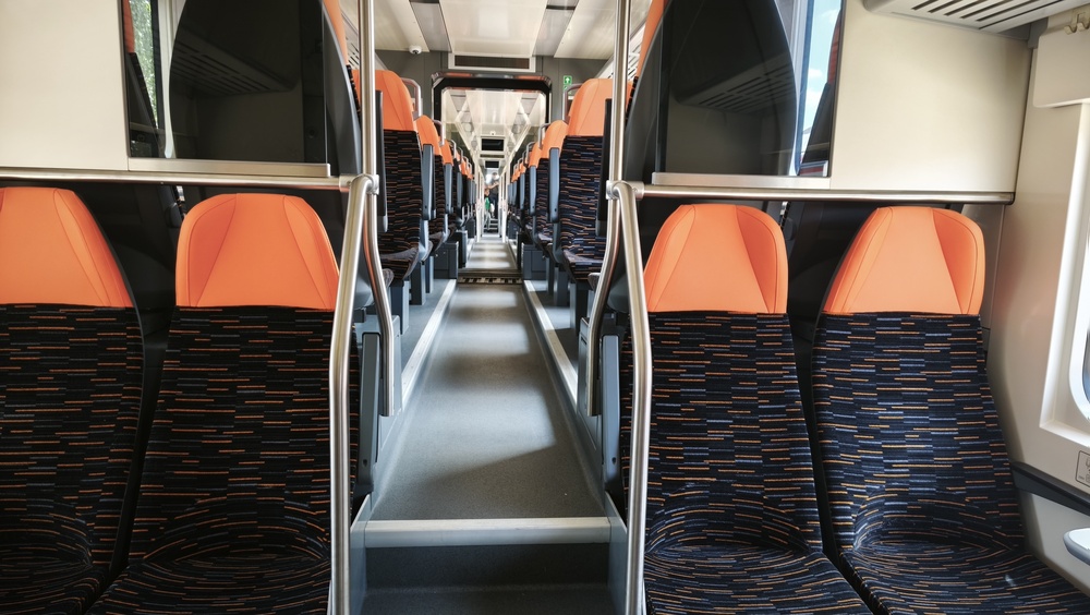 Empty Modern Train Interior with Orange Passenger Seats and Aisle View