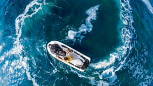 Man operating personal watercraft in the open water.