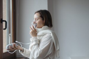 female patient using a portable oxygen concentrator for a respiratory therapy